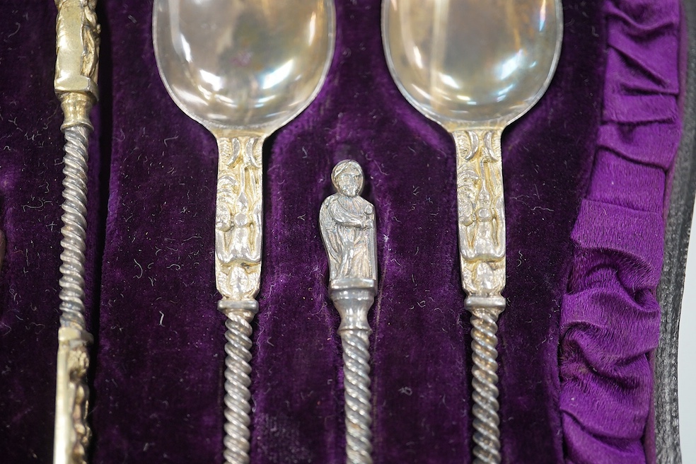 A cased set of six Victorian silver apostle teaspoons, tongs and caddy spoon, 1882, 3.7oz, and a cased George VI silver christening set comprising egg cup, napkin and spoon, 2.6oz. Condition - good.